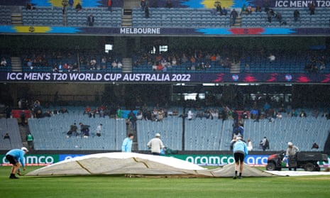 Ground staff cover the pitch due to a rain delay