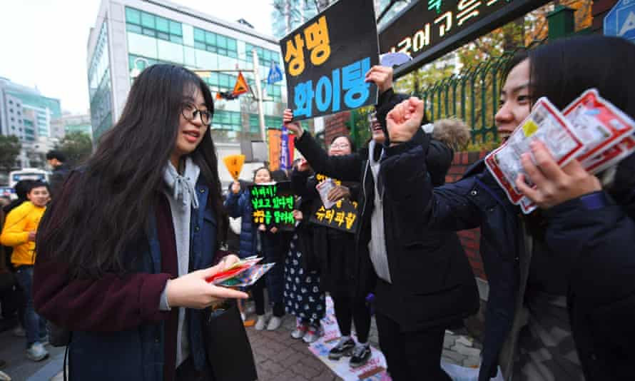 Students cheer in support as others arrive to sit the annual college entrance exam in Seoul.
