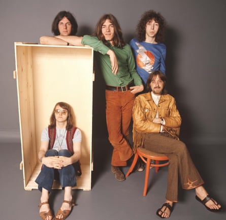 Band pose against a grey background
