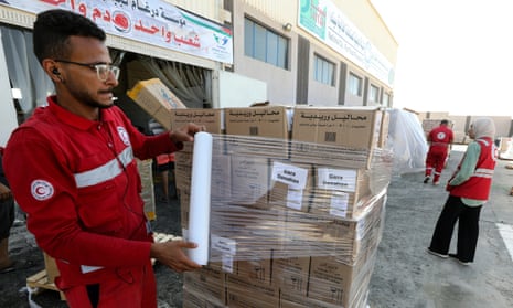 Egyptian Red Crescent society staff prepare humanitarian aid bound for the Gaza Strip at a warehouse in Arish, Egypt.