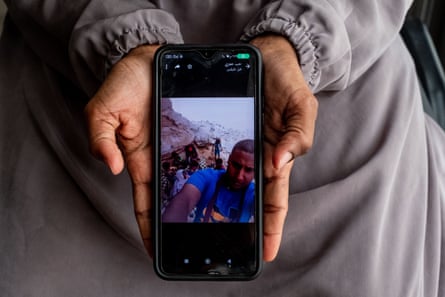 Nasra shows a photo on her phone of her husband and children during their long journey from Yemen