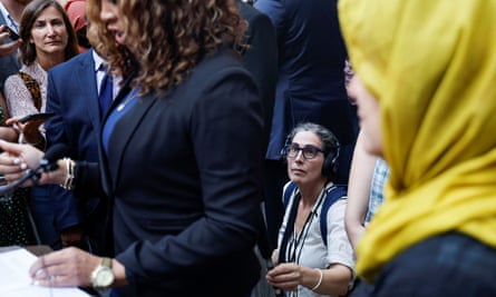 Sarah Koenig with her microphone at the court in Baltimore as the judge overturns Adnan Syed's conviction