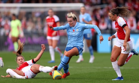 Lauren Hemp of Manchester City is challenged by Victoria Pelova of Arsenal.