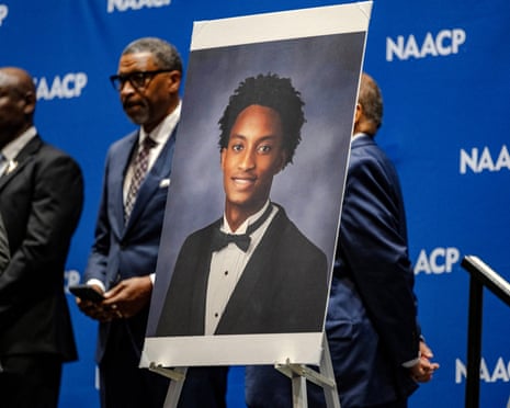 a photo of Nolan Wells is displayed at a press conference