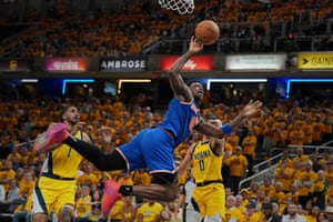 Basketball player contorted to take a shot