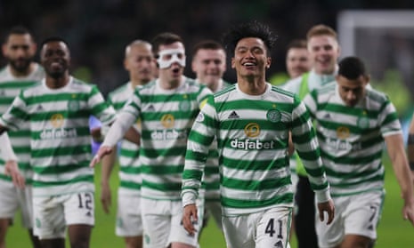 Reo Hatate leads the post-game celebrations after scoring twice to help Celtic leapfrog Rangers at the top of the Scottish Premiership.