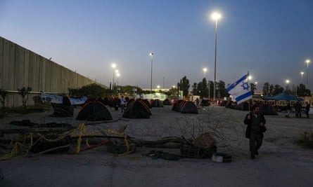 Israeli activists set up tents to block trucks carrying humanitarian aid into Gaza Strip at the Kerem Shalom border crossing