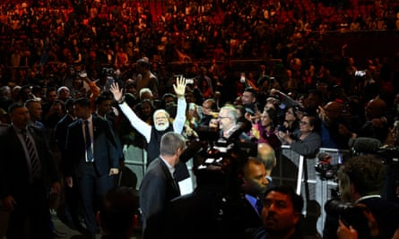 Modi waves as Albanese, to his right, watches at the event