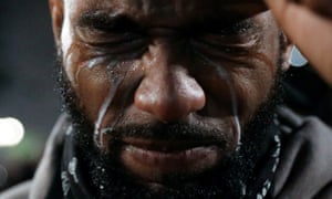 A protester reacts to milk poured on his eyes after being tear gassed during a protest against racial inequality in Portland, Oregon, 19 July