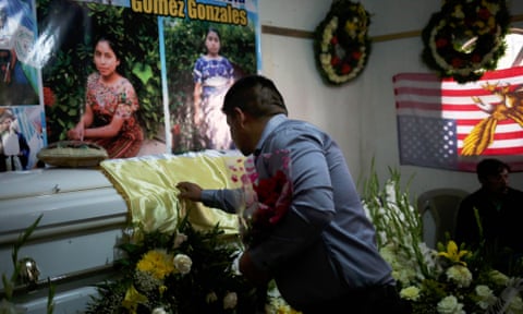 A family member touches the coffin of Claudia Gómez during her wake in La Union Los Mendoza in western Guatemala.