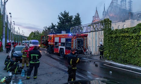 Ukrainian firefighters work at the site of a burning building damaged as a result of a missile attack, in Odesa.