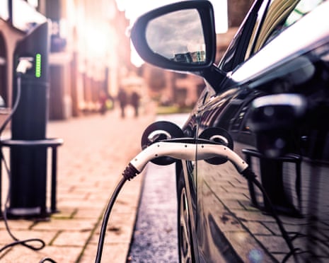 Electric vehicle being charged on street