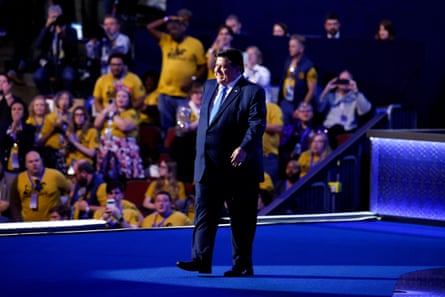 a man walks on stage as people cheer