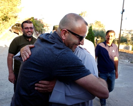A man hugging his family.