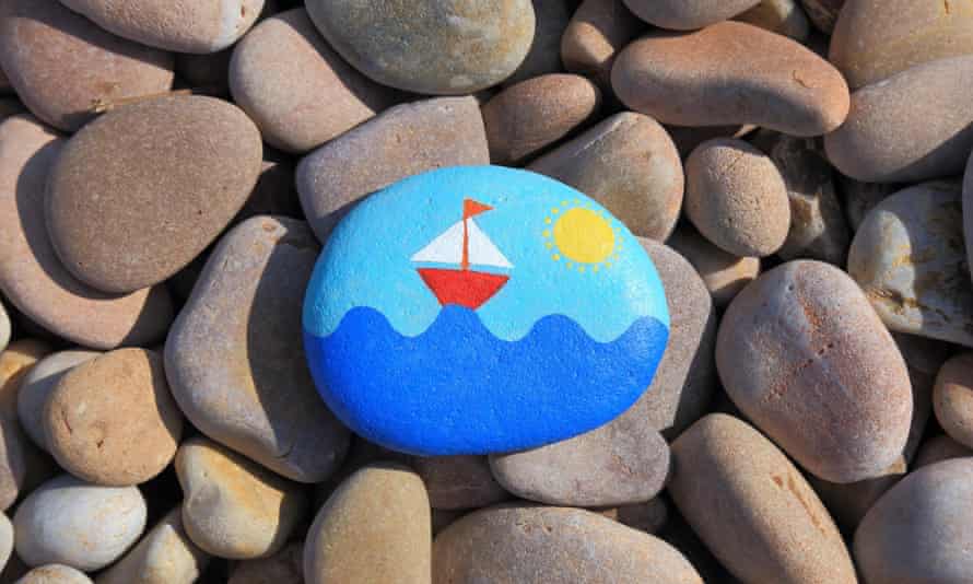 Red sailing boat painted on a pebble