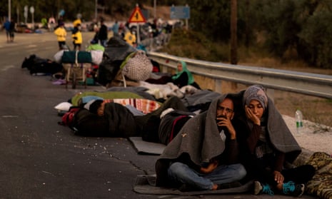 Refugees and migrants camp on a road following a fire at the Moria camp in Greece.