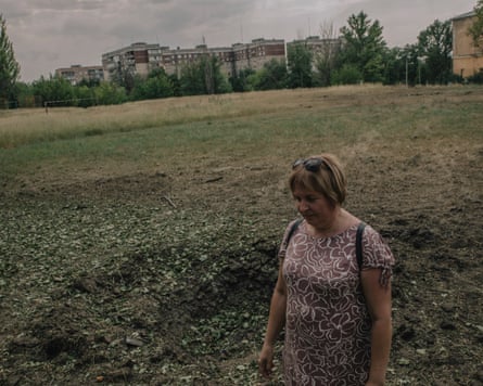Woman standing in front of a crater