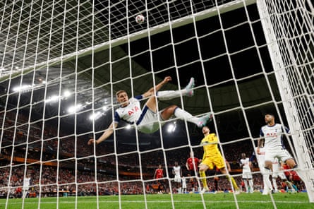 Micky van de Ven acrobatically clears a Rasmus Højlund header off the line