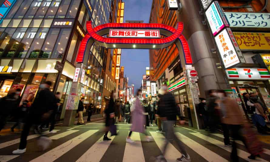 Pedestrians cross a street in Tokyo’s Shinjuku area