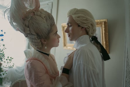 Alice Englert and Nicholas Denton in period costume share a glance in a scene from Dangerous Liaisons
