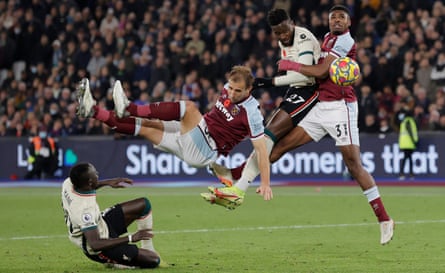 Divock Origi of Liverpool misses a late chance to equalise as Craig Dawson and Ben Johnson defend for West Ham at the London Stadium.