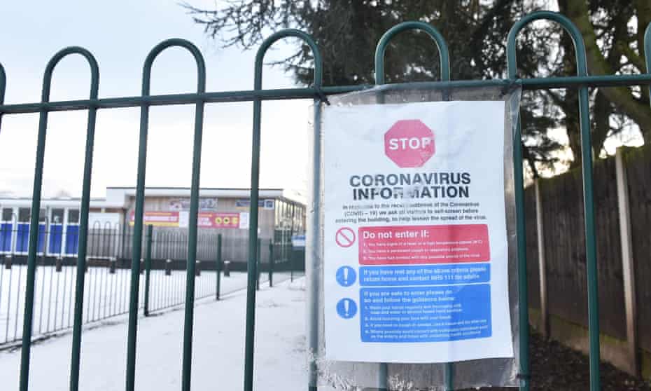 A coronavirus sign is displayed outside a primary school in Newcastle Under Lyme, England.