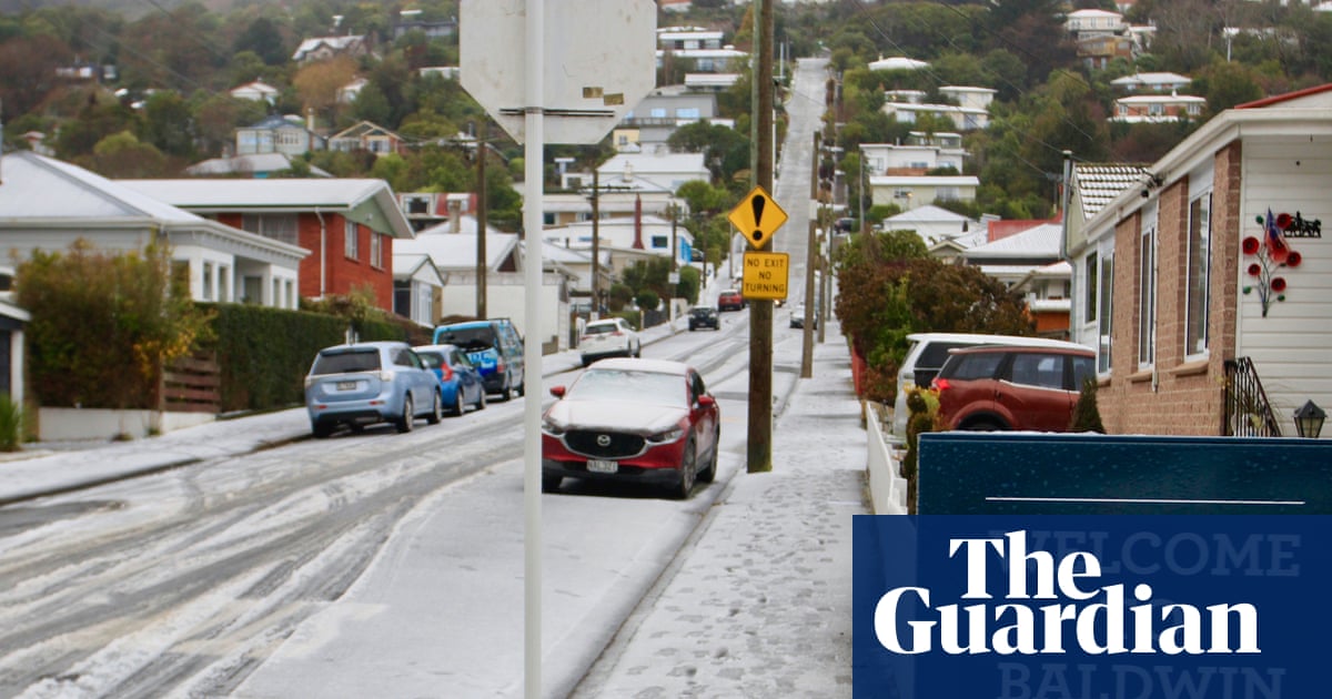 New Zealand capital delights in rare snowfall as southern city residents ski down world’s steepest street