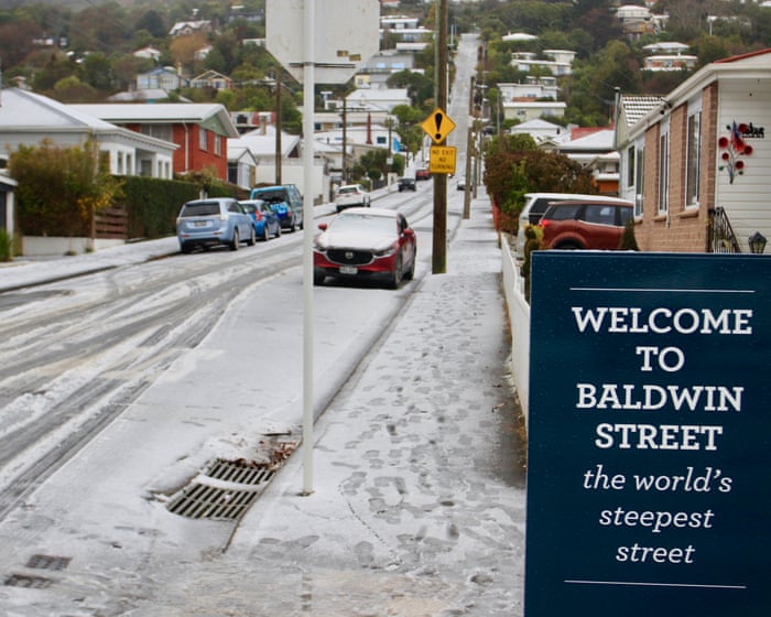 New Zealand capital delights in rare snowfall as southern city residents ski down world’s steepest street — image supplied by The Guardian World's feed