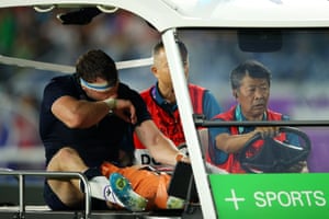 Hamish Watson of Scotland is taken by a cart after twisting his knee.