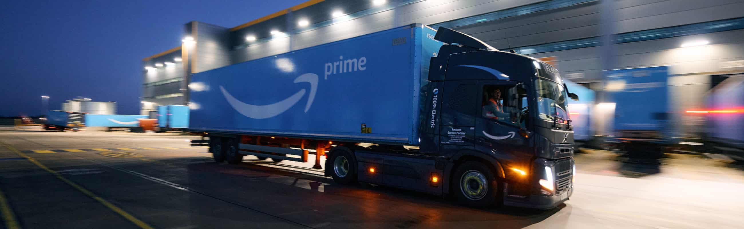 Amazon truck outside distribution centre at dusk