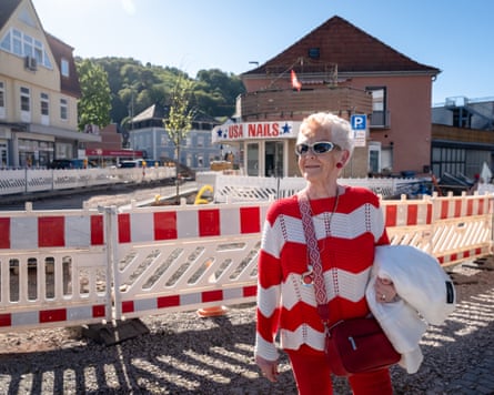 Helga stands in Landstuhl centre with a shop called USA Nails in the distance.