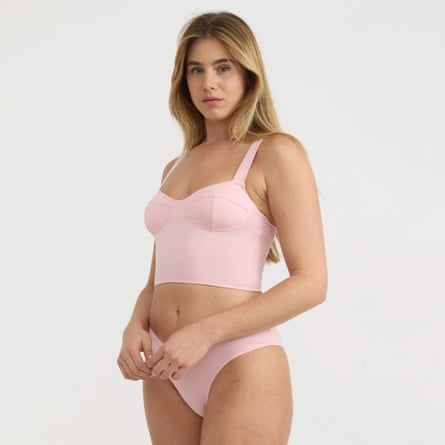A model wears a pastel pink corset top.