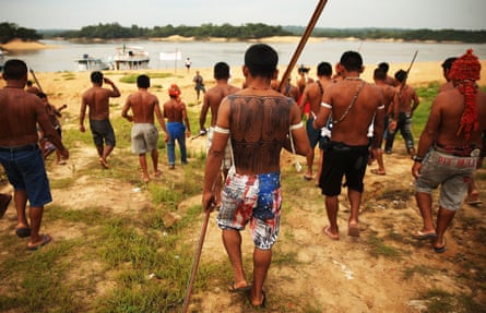 Members of the Munduruku indigenous tribe walk down to the Tapajós river during a protest by indigenous groups.