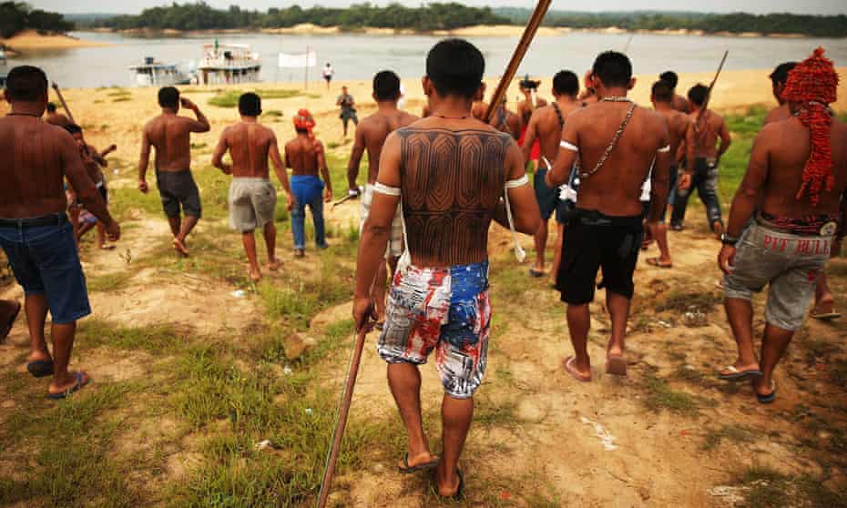 Members of the Munduruku indigenous tribe protest the construction of a hydroelectric dam on the Tapajos River in the Amazon rainforest, 2014.