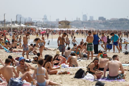 Hoards of people gather on a beach
