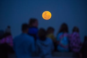 Families watch the super moon rising over the Cedarberg Mountains in South Africa