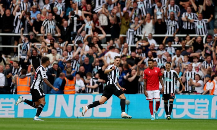 Newcastle United’s Fabian Schar celebrates scoring their first goal with team-mates as Nottingham Forest’s Jesse Lingard looks dejected.