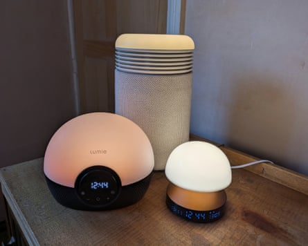 Three sunrise alarms on a bedside table