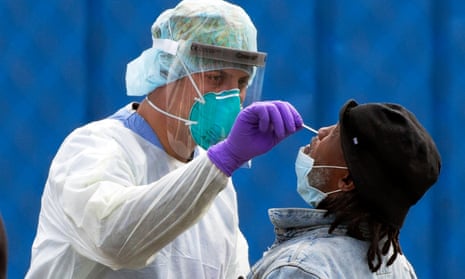 A medical worker performs a Covid-19 test on a patient at a walk-up site in Boston, Massachusetts.