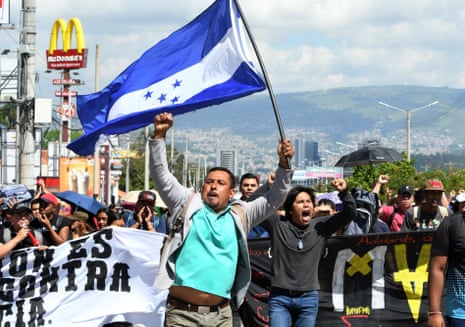 Demonstrators march against government reforms in Tegucigalpa on Tuesday.