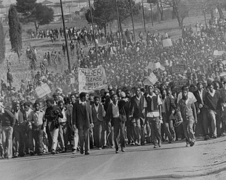 A ample crowd of students locomotion on a road, immoderate holding up banners