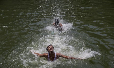 Boys swimming to cool off as record temperatures of 51C were recorded in the Indian city of Phalodi. 
