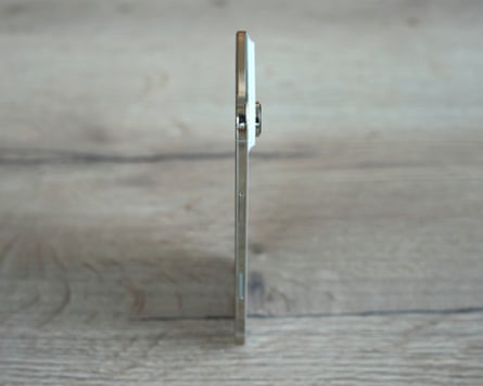 The iPhone Air pictured in side profile stood up on a wooden table.