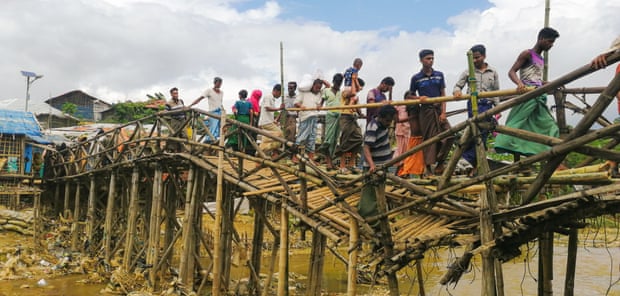 Rohingya refugees cross a river inside the camp over a damaged bridge.  A photo by Sahat Zia Hero.