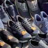 Several pairs of slip-on shoes sitting on outdoor couch