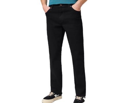 A cropped at waist image of a model wearing black Wrangler Texas jeans