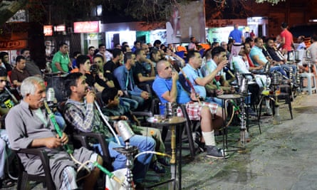 Jordanians smokign while watching a football match.