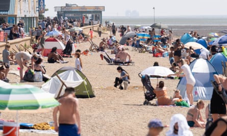 A sandy beach full of people