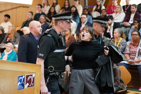 A protester being removed from the public gallery at Holyrood today.