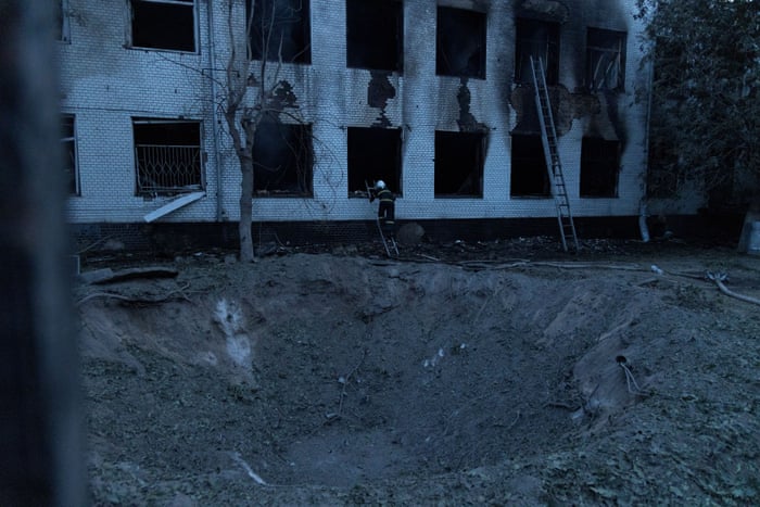 A shell crater is seen in front of a hospital building in Mykolaiv.